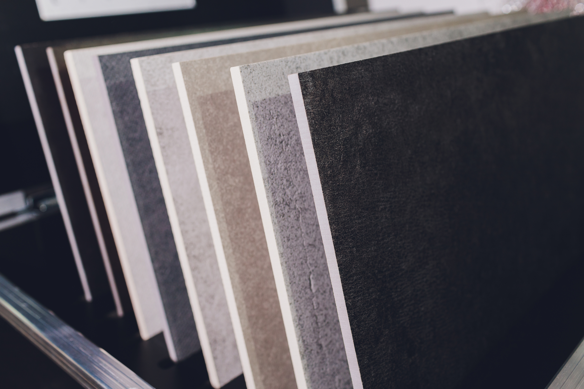 Various stone tile samples on display rack.