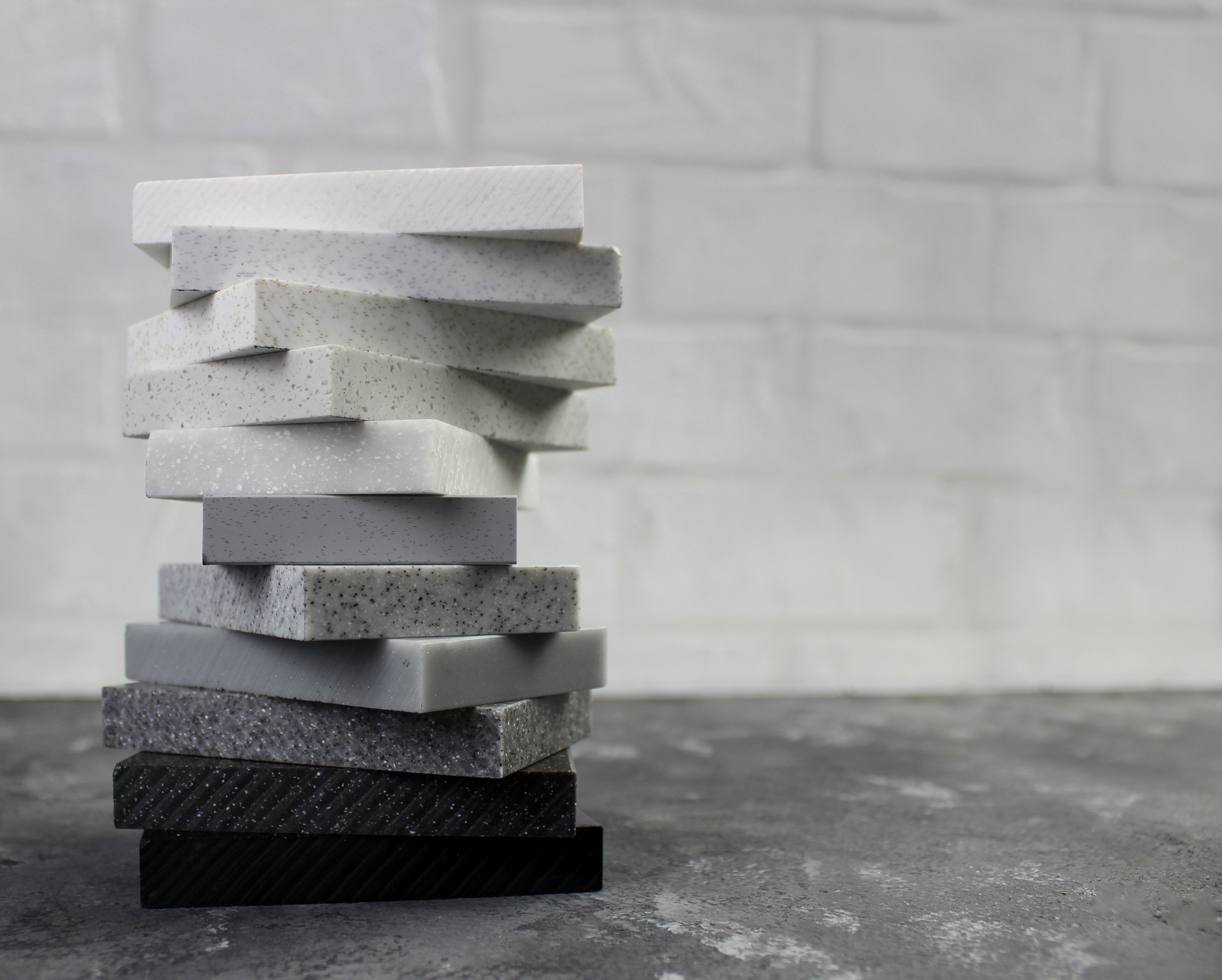 Stack of stone samples on concrete surface.